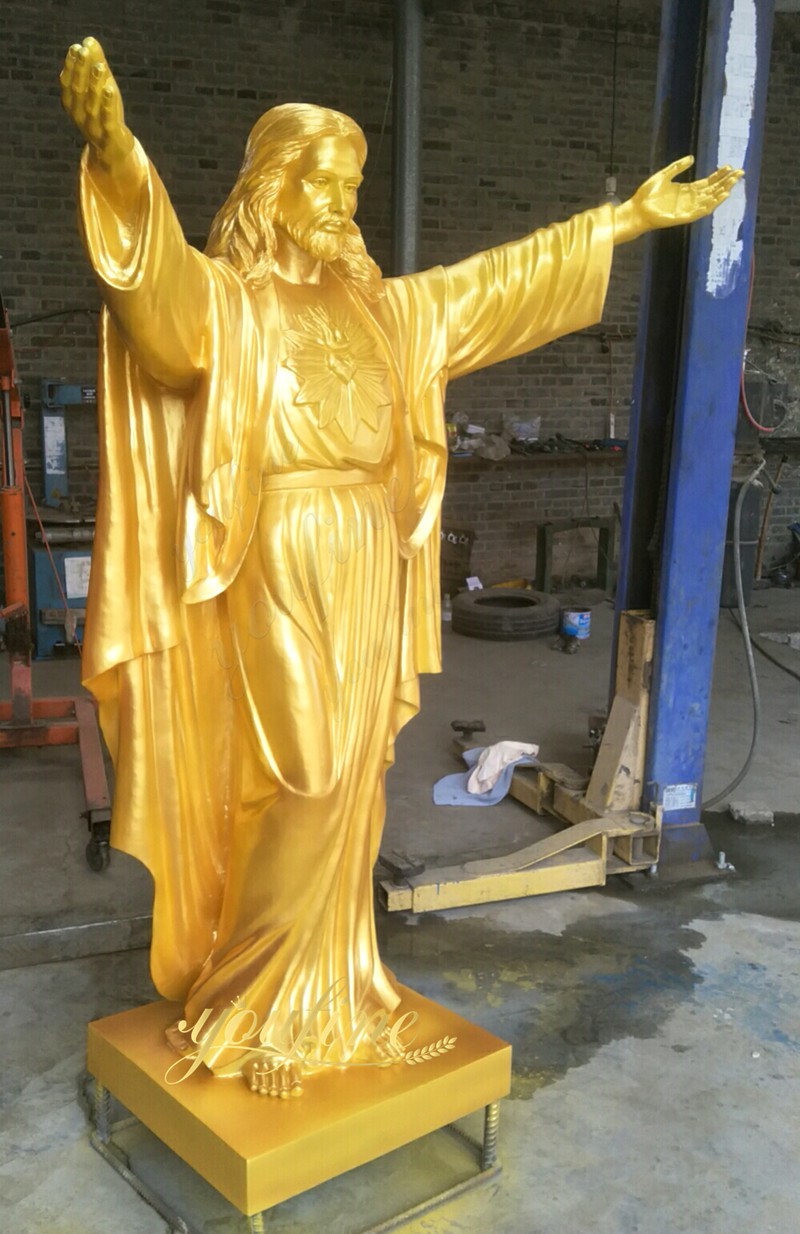 large golden jesus sculpture in factory